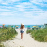 Woman walking toward beach in Myrtle Beach, SC