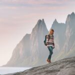 Tourist woman traveling in Norway active lifestyle vacations outdoor Okshornan peaks landscape Senja island